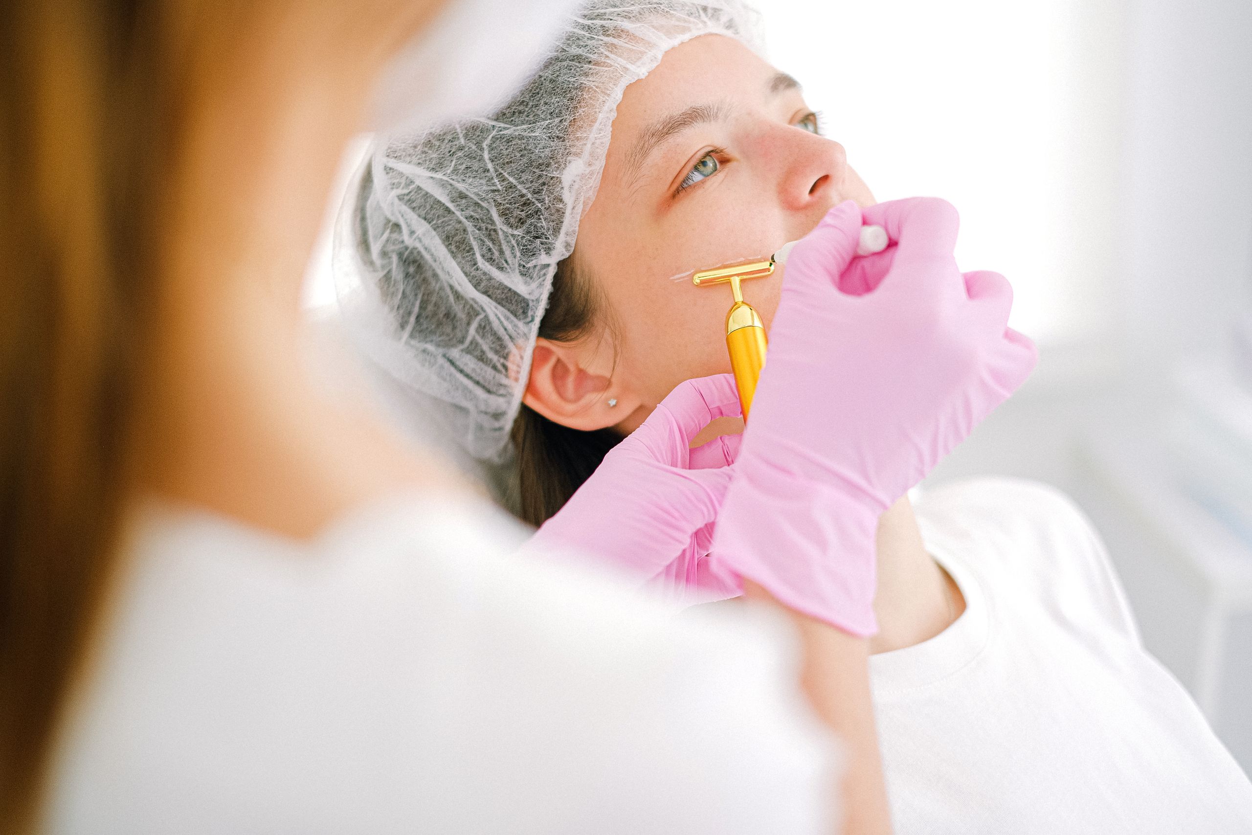 Close-up of a woman receiving a facial treatment at a beauty spa.